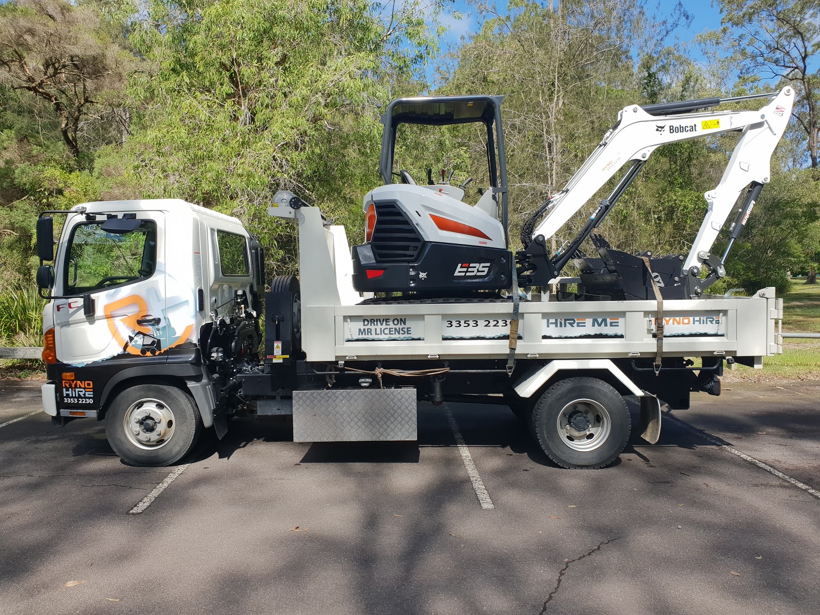 Bobcat excavator on a carrier truck