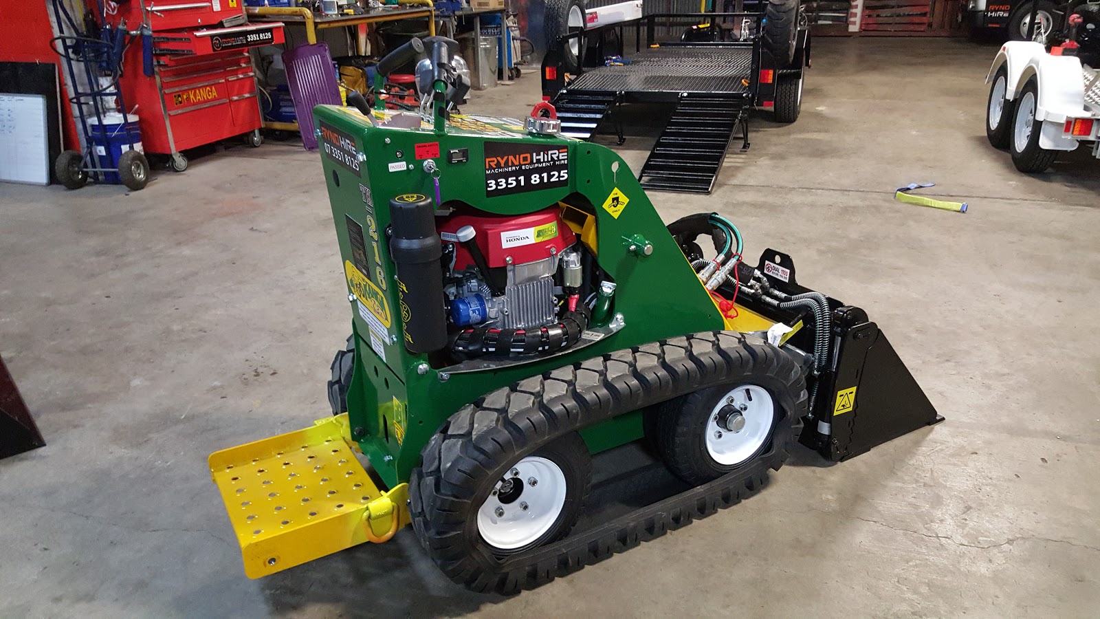 A rear-view of green-yellow micro loader