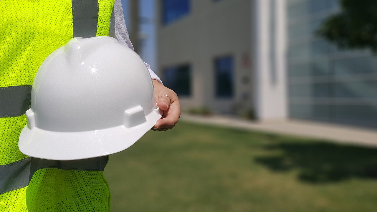 A person is holding a safety hat
