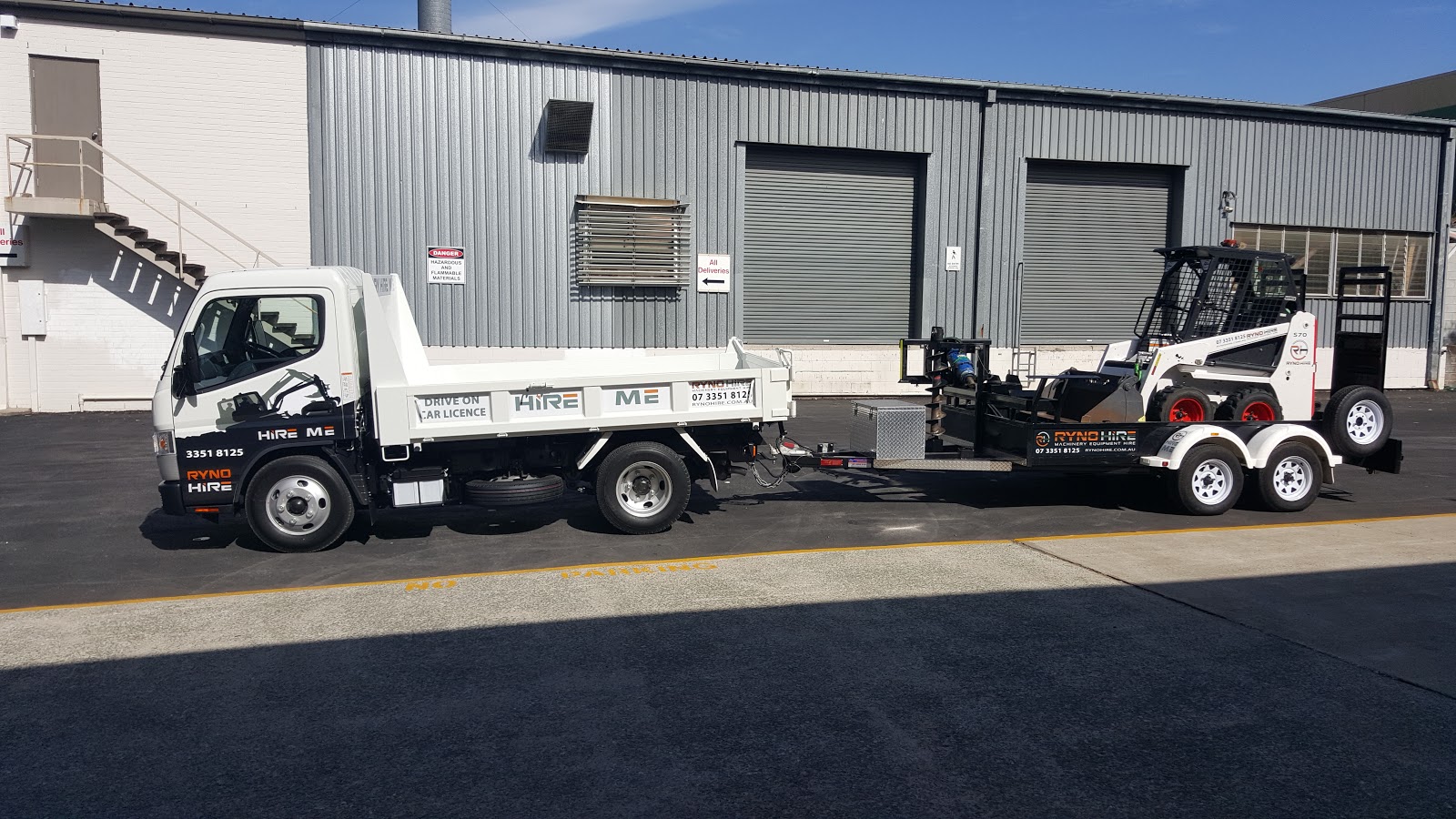 ryno hire's tipper is towing a loader