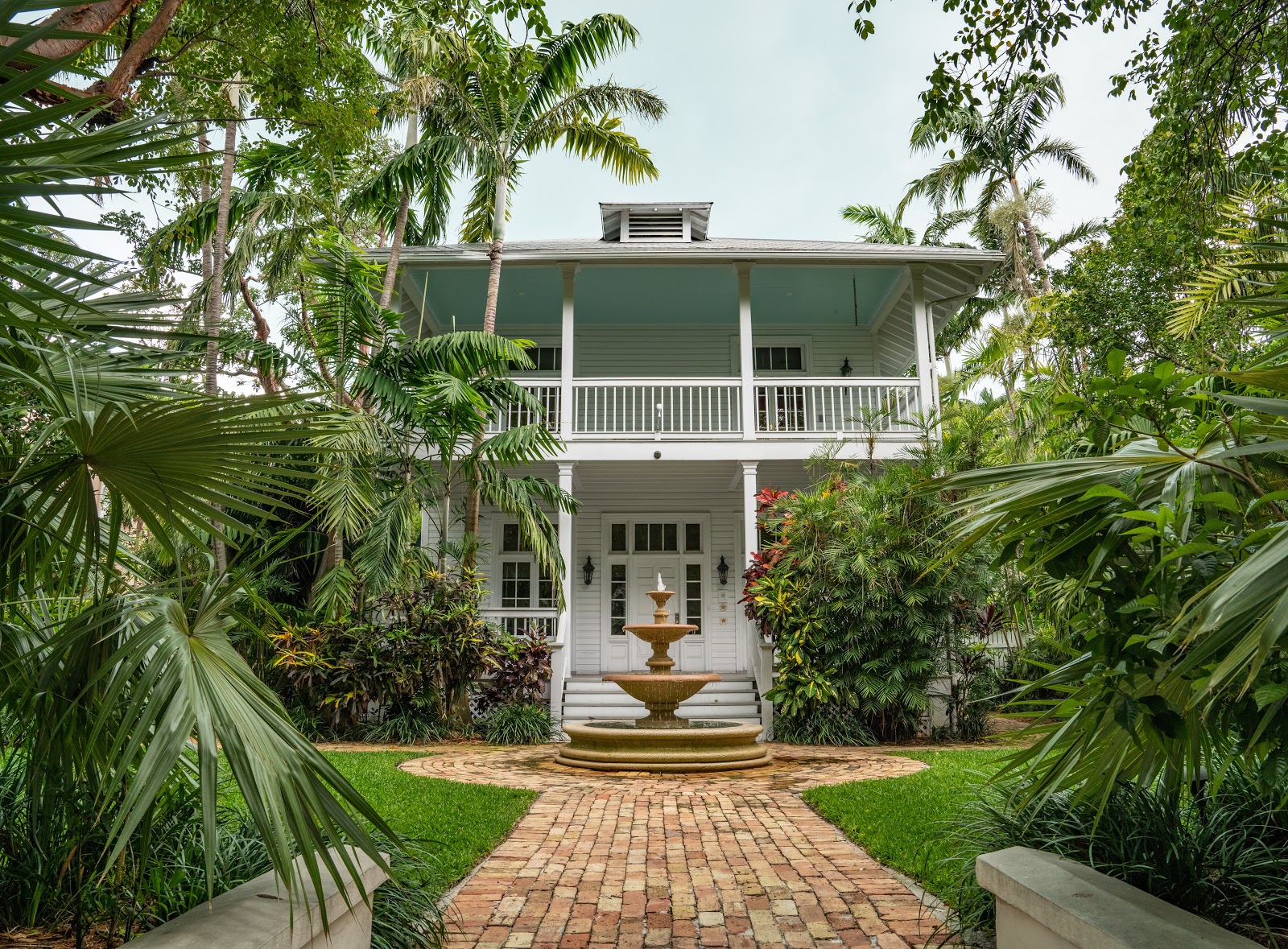 A front-view of a house with plants surrounding