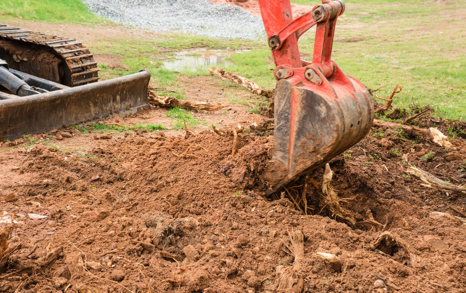 excavator digging deeper on soil