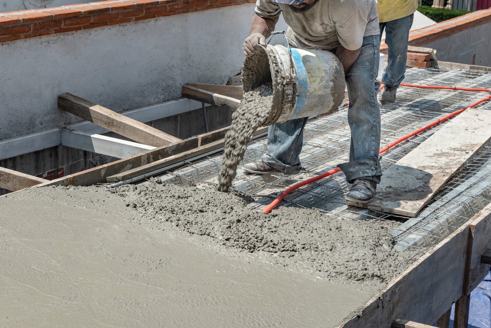 A constructer is laying concrete on construction site