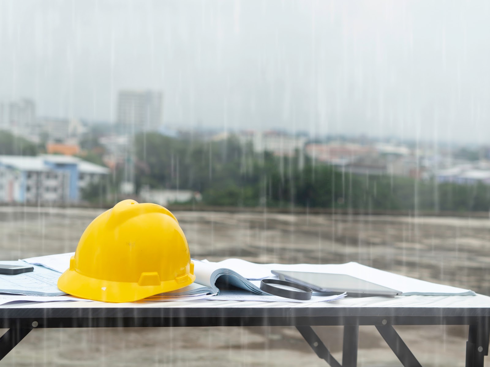 A yellow safety hat in raining weather