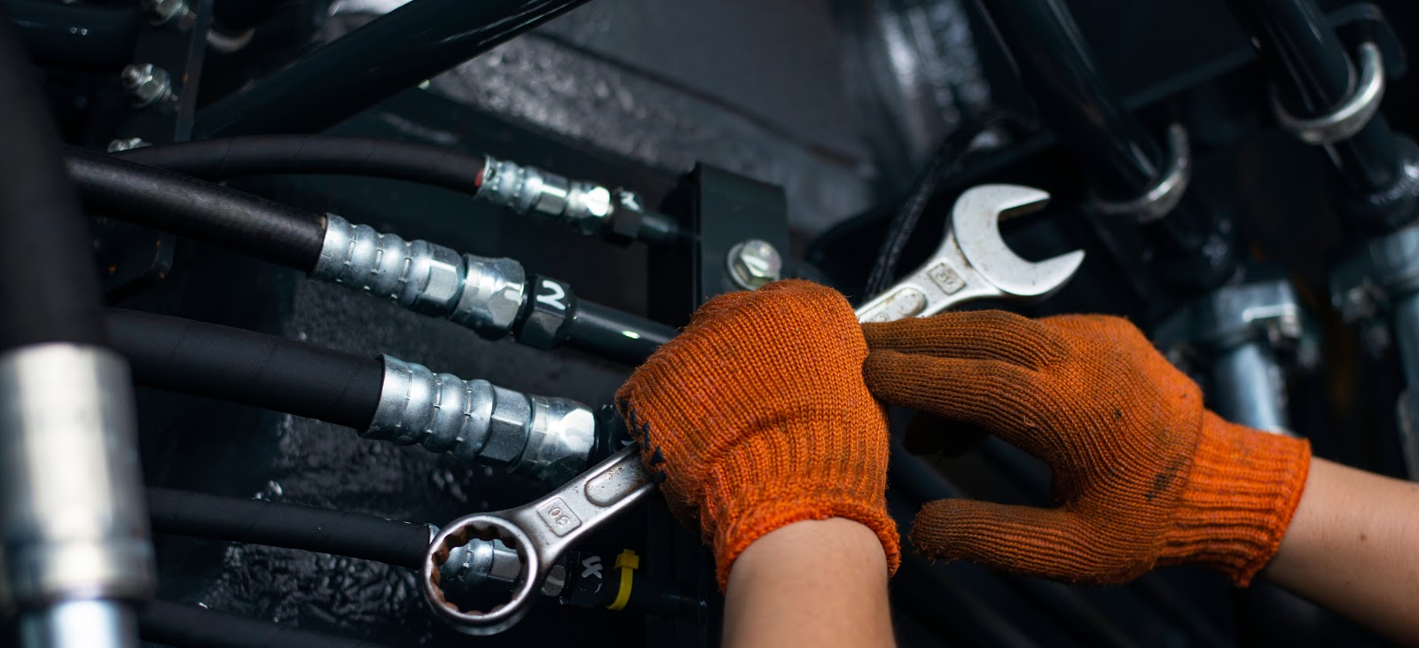 A pair od hand with gloves fixing the equipment mechanism