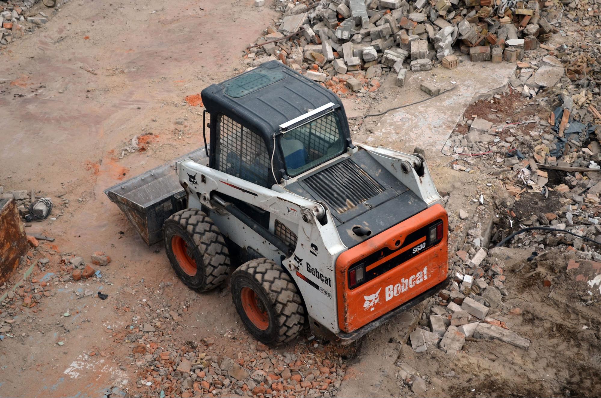 A white bobcat loader in a construction site