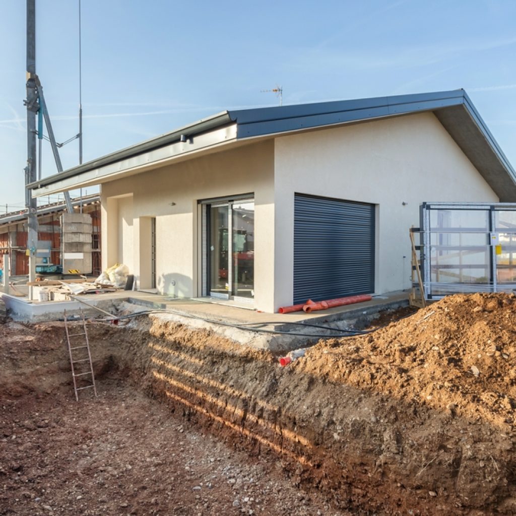 The backyard of a house excavated in preparation for a pool.